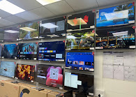 Smart TV display wall inside the Super Sales & Services showroom in Surat.
