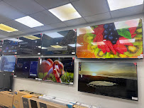 Smart TV display wall inside the Super Sales & Services showroom in Surat.